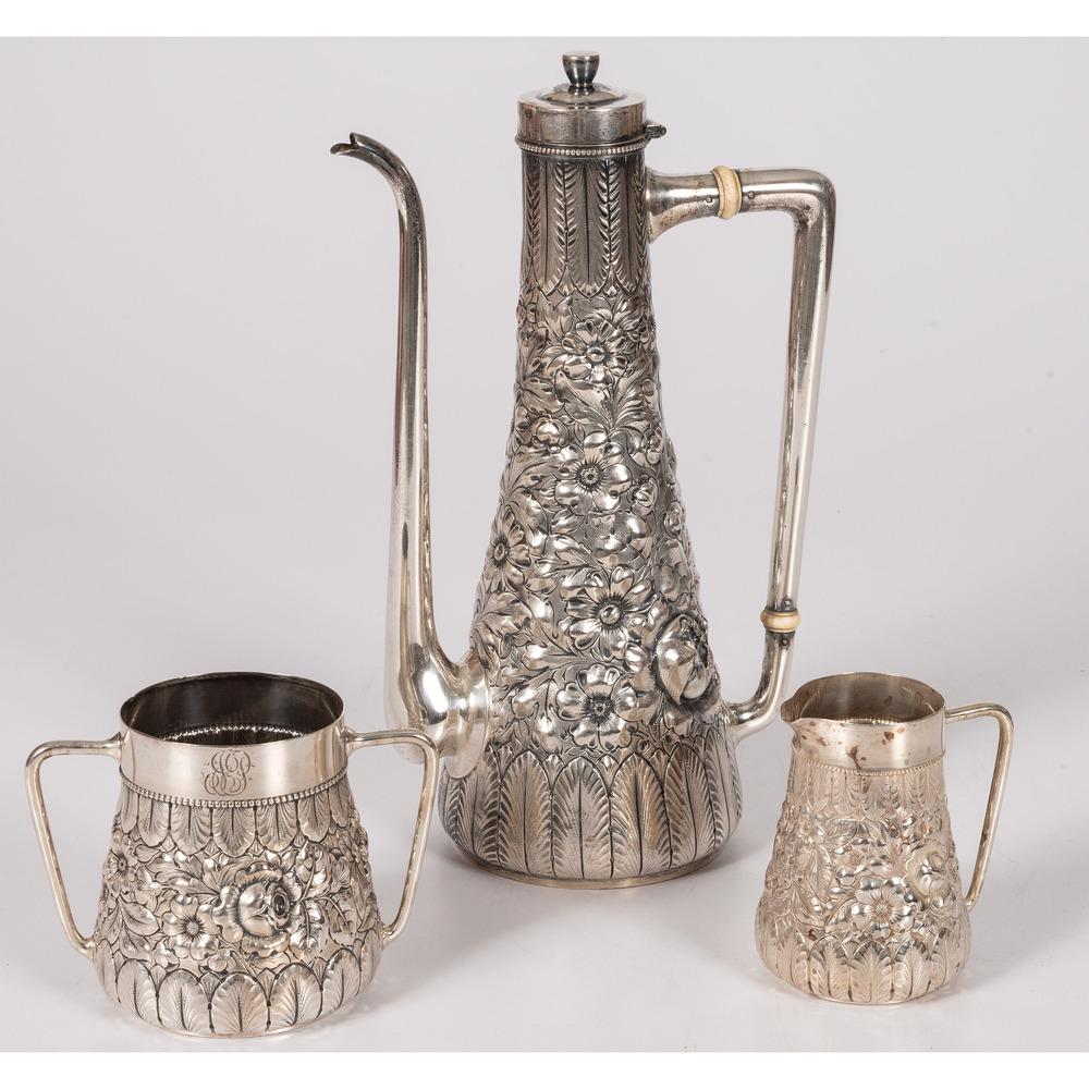 A Gorham Silver Coffee Service in the Turkish Style: American, 20th Century three-piece repousse sterling service, including coffee pot, creamer and sugar. each marked for Gorham and Sterling and with 3437 to underside. Height of coffee pot 11 1/2 