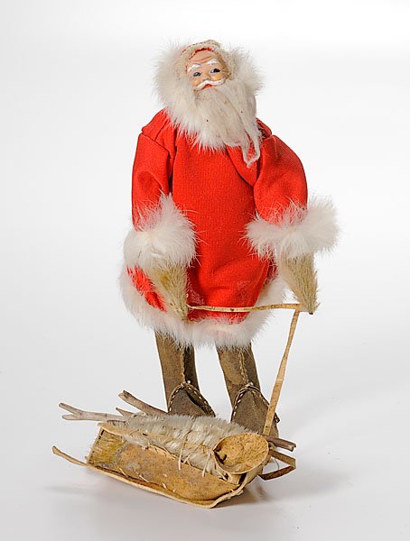 Eskimo Santa Claus Doll by Rosalie Paniyuk : Eskimo Santa Claus Doll by Rosalie Paniyuk with molded face, sealskin boots; Santa pulls a rawhide sleigh laden with fishing accouterments and seal hides, height 11.5". late 20th century