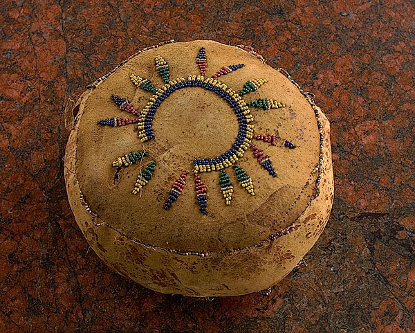 Apache Shinny Ball, : Apache Shinny Ball, late 19th century thread-sewn using colors of cobalt, greasy yellow, translucent green, and clear; beaded on both sides and stuffed with wool, height 3.5" x diameter 7.5". Likely