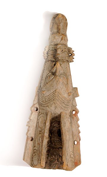 Papua New Guinea Canoe Prow : Papua New Guinea Canoe Prow fully carved with crocodile emerging from ancestral face; traces of red pigment, length 23". Property of the Children's Museum of Indianapolis