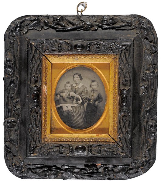 Sixth Plate Ambrotype of Soldier's Family in Wall: Sixth Plate Ambrotype of Soldier's Family in Wall Frame, anonymous mother and two children mounted in elaborately carved wooden frame with floral design. The young wife holds her daughter who in tur
