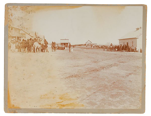 D.F. Barry Photograph of Sioux Indians Receiving R: D.F. Barry Photograph of Sioux Indians Receiving Rations, likely Dakota Territory, ca. 1890s. Image blind-stamped BARRY in foreground. As the men cluster around the agency, their women huddle on the