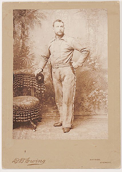 Fine Anonymous Albumen Photo of Cowboy, : Fine Anonymous Albumen Photo of Cowboy, albumen print, 5.5" x 7.5" is full length portrait of a young man in buckskin with holstered revolver on belt on original card stock mount with imprint of D.B