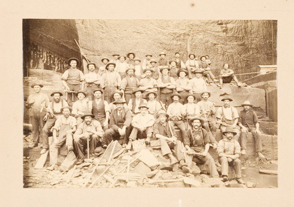 Photograph of Quarry Miners, : Photograph of Quarry Miners, anonymous image of large group of miners with their tools in a granite quarry, 5.5" x 8.25", mounted on original card stock, 8" x 10".