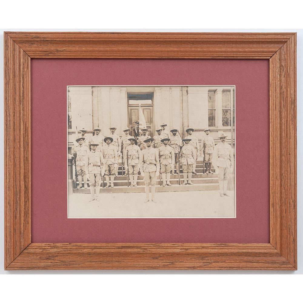 [AFRICAN AMERICANA] -- [MILITARIA]. Photograph of: [AFRICAN AMERICANA] -- [MILITARIA]. Photograph of African American soldiers. Silver gelatin photograph of group of uniformed men posed outside on building steps, n.p., n.d. Approx. 9.5 x 7.5 in (sight