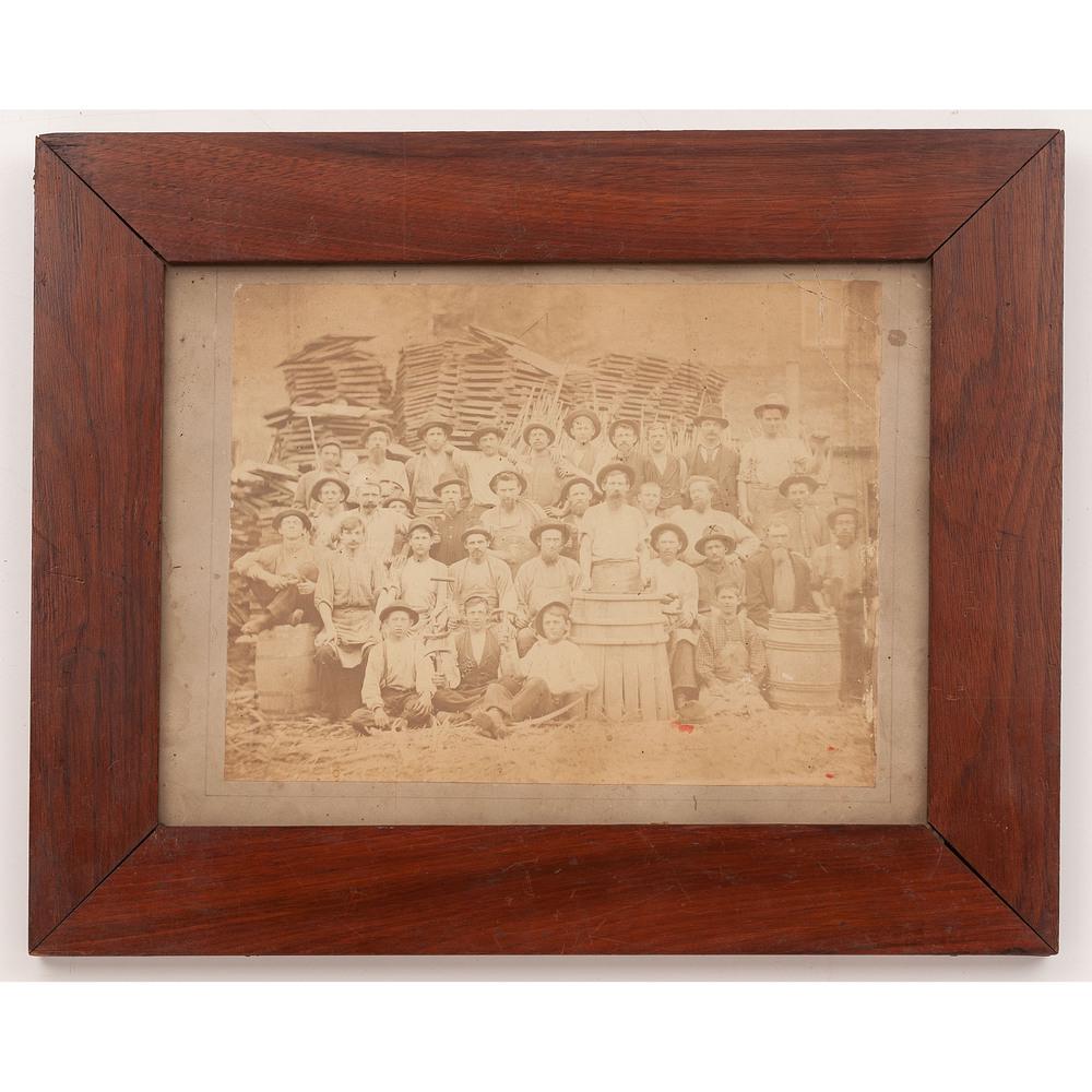[EARLY PHOTOGRAPHY - OCCUPATIONAL] Outdoor photograph: [EARLY PHOTOGRAPHY - OCCUPATIONAL] Outdoor photograph of a group of coopers. N.p., n.d. 9 1/2 x 7 3/4 in. large-format albumen photograph (toning, tear to upper corner, a few red spots), framed to 15