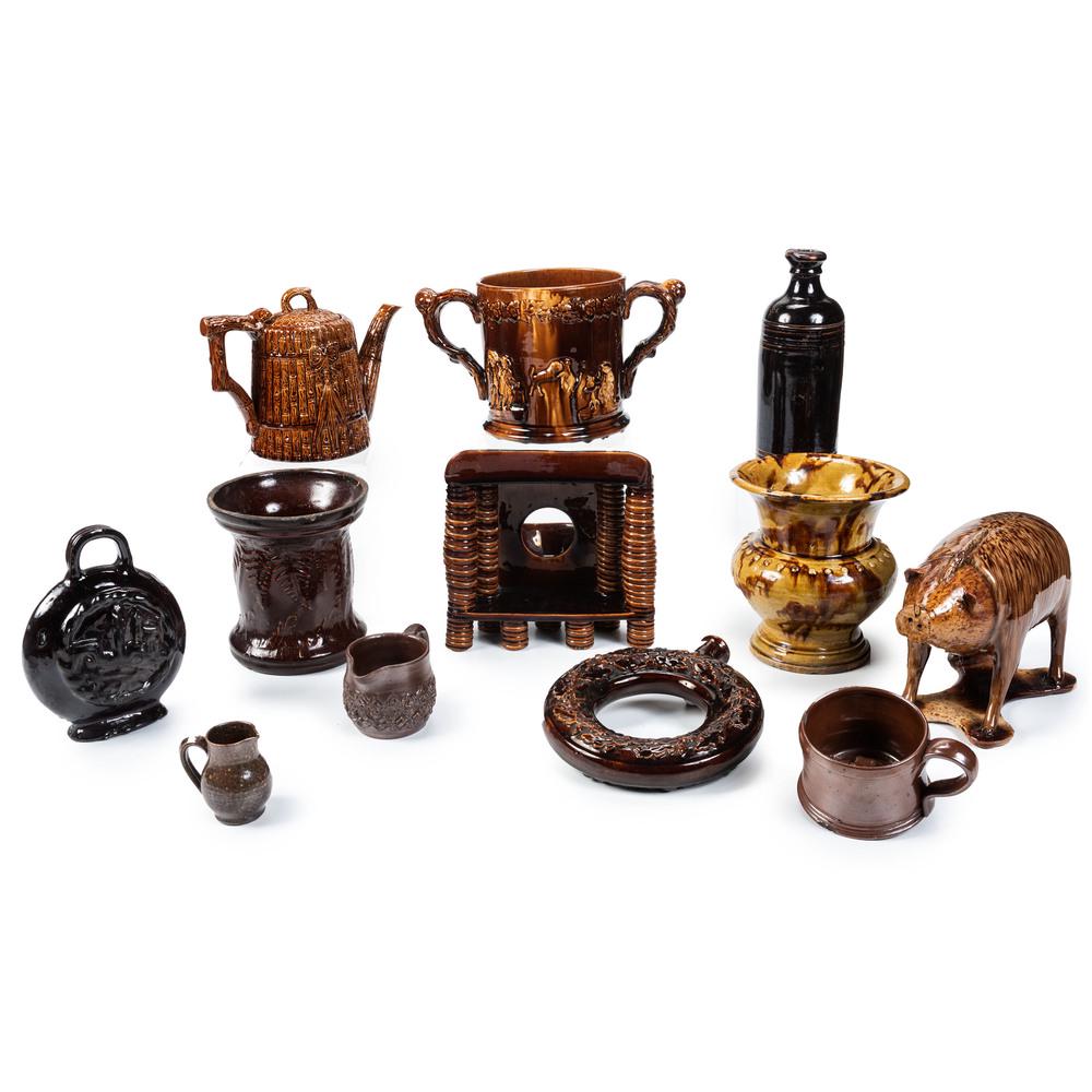 Twelve Pieces of Rockingham Glaze Pottery and Redware: Twelve Pieces of Rockingham Glaze Pottery and Redware English and American, 19th/20th Century twelve pieces including a standing pig jar, a double-handled jar, two vases, a watch hutch, a redware crea