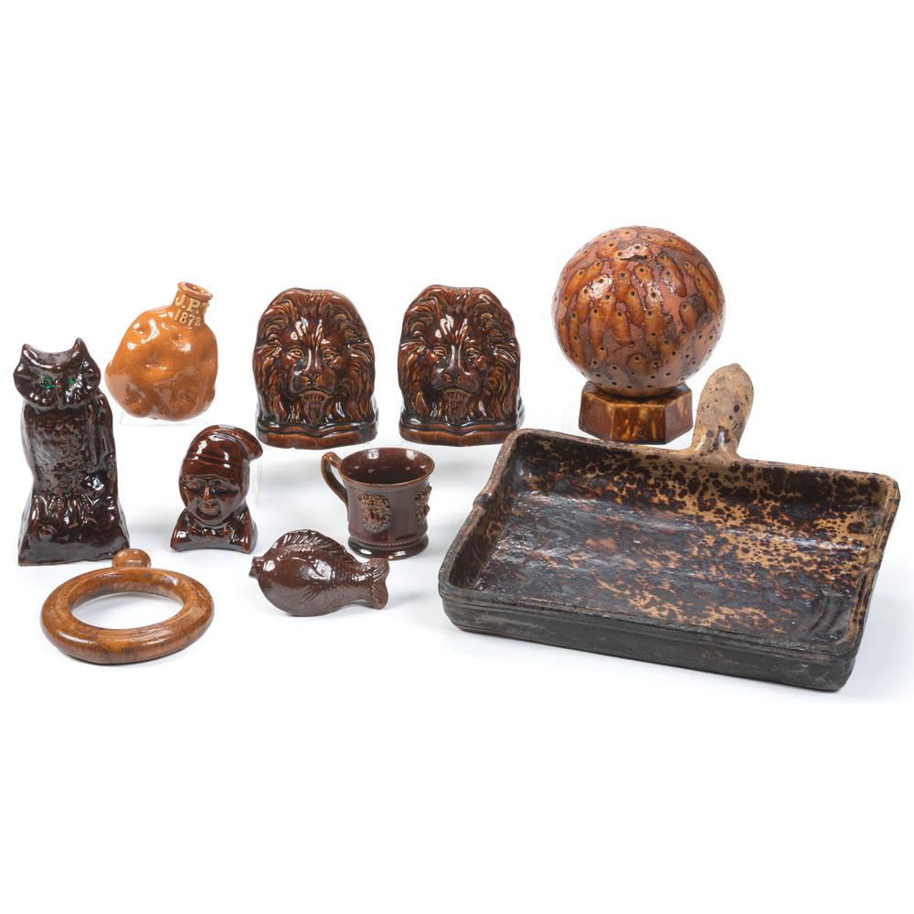 Ten Rockingham Glaze and Redware Articles: Ten Rockingham Glaze and Redware Articles 19th/20th Century including a potato flask initialed J.P.T. and dated 1872, a ring flask, a carpet ball, a pair of bookends, a bank, a pan, an owl figure, a f