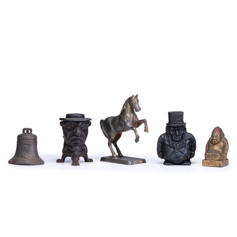 Four Figural and Patriotic Cast Iron Still Banks: Four Figural and Patriotic Cast Iron Still Banks American, Late 19th/Early 20th Century including two men wearing hats, one billiken, one rearing horse, and one Liberty Bell, together with a lidded m