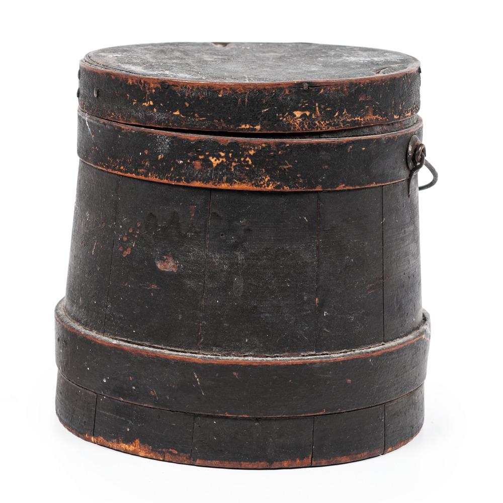 A Firkin in Old Black Paint: A Firkin in Old Black Paint 19th Century with lid and swing handle. Height 6 1/2 x diameter 6 3/4 inches. Property of the late Karen Tosterud, Bellaire, Michigan We are pleased to offer the collection
