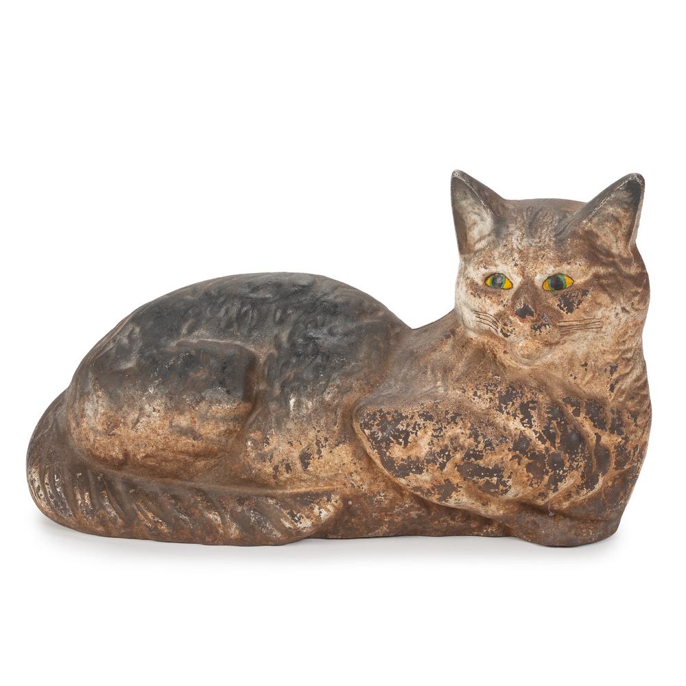 A Painted Cast Iron Reclining Cat Doorstop: A Painted Cast Iron Reclining Cat Doorstop Height 7 1/2 x length 12 1/2 inches. Property of the late Karen Tosterud, Bellaire, Michigan We are pleased to offer the collection of Karen Renae Tosterud (