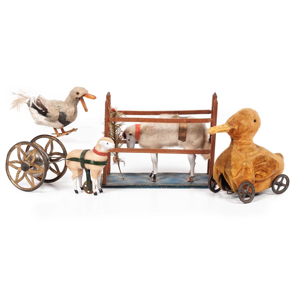 Four Sheep and Duck Toys, Including Pull Toys: Four Sheep and Duck Toys, Including Pull Toys including a composite sheep pull toy, a cloth duck pull toy, a composite sheep on a fenced platform and a papier mache duck toy with feathers. Height of p