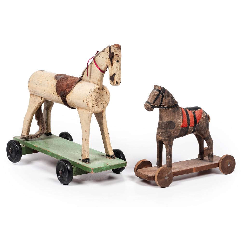 Two Wooden Horse Pull Toys: Two Wooden Horse Pull Toys each with an applied saddle and wooden platform. Height of largest 11 1/2 x length 11 x depth 3 1/2 inches. Property of the late Karen Tosterud, Bellaire, Michigan We are pl
