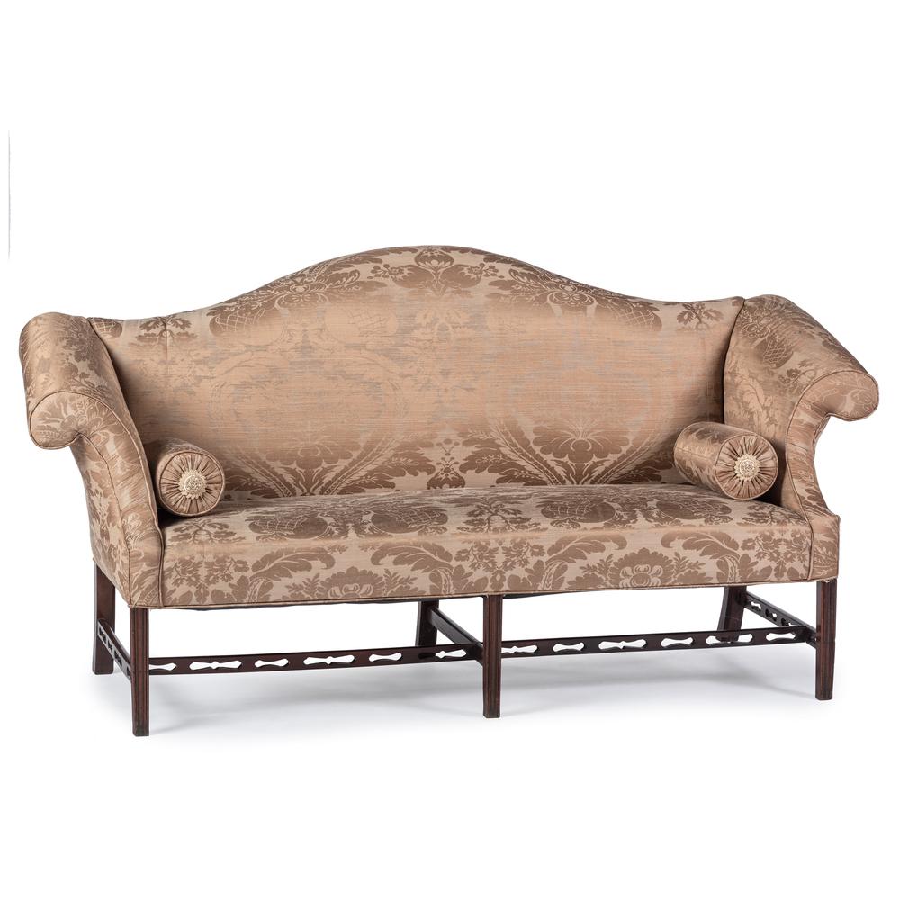 A Chippendale Style Carved Mahogany Camel Back Sofa: A Chippendale Style Carved Mahogany Camel Back Sofa with Bolsters 19th/20th Century Height 39 x width 73 inches.