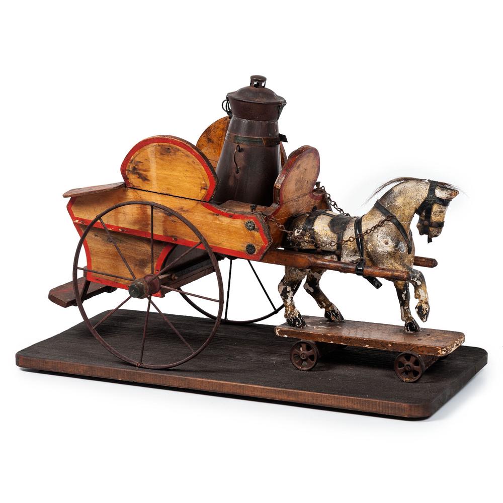 A Horse-Drawn Wagon Pull Toy: A Horse-Drawn Wagon Pull Toy Late 19th/Early 20th Century having a wooden wagon with paint decoration, iron wheels, fitted with a tin cannister and two tin pails, all mounted on wooden platform. Heigh