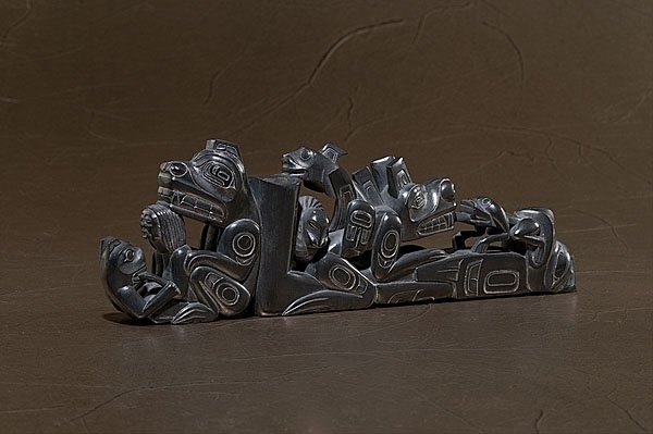 Ding Hutchingson Haida Argillite Pipe : Ding Hutchingson Haida Argillite Pipe, fully carved with a woman, bear, Wasco, and a frog; finishing the pipe is an eagle; signed and dated on bottom, length 10". 1995