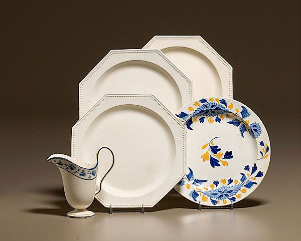 English Creamwares, : English Creamwares, ca 1780-1800. Five pieces, including three octagonal plates with beaded edges, one with impressed Stevenson, a gaudy creamware SPODE plate, and a helmet form Wedgwood cream jug.