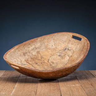 Eastern Woodlands Elm Burl Feast Bowl: exceptionally large bowl having rectangular handles and remnants of old red paint height 7.25 in. x length 25.5 in. x width 18.25 in. late 18th century cf. Powers, Steven. North American Burl