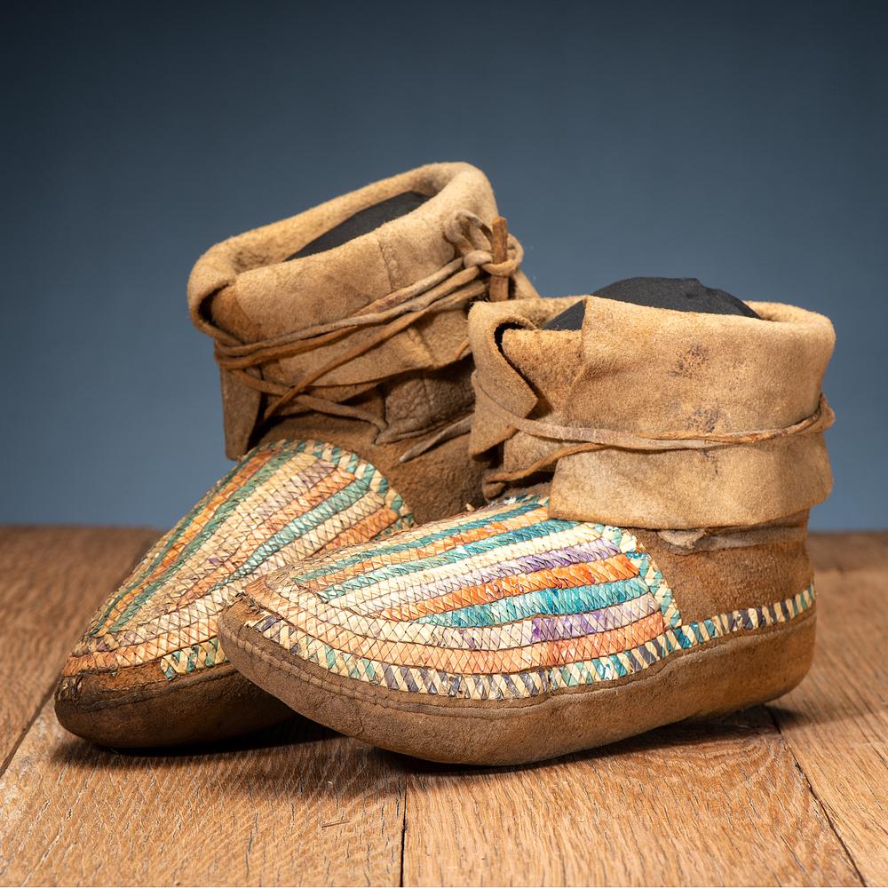 Northern Plains Quilled Moccasins: sinew-sewn and quilled on thick hide, having vertical stripes on vamps length 10 in. fourth quarter 19th century