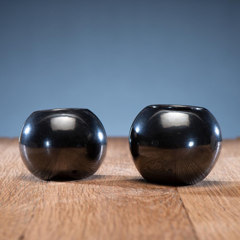 Maria Martinez (San Ildefonso, 1884-1980) Blackware: both jars of bulbous form with high polish, signed on base Maria Poveka largest height 3 in. x diameter 4 in. 1956-1965