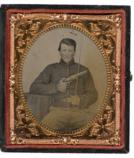 Sixth Plate Ambrotype of Armed Union Cavalryman: Sixth Plate Ambrotype of Double Armed Union Cavalryman. A portrait of an unidentified trooper holding Colt Navy revolver and sword shaped like Foot Officer model with brass hilted single branch guard.