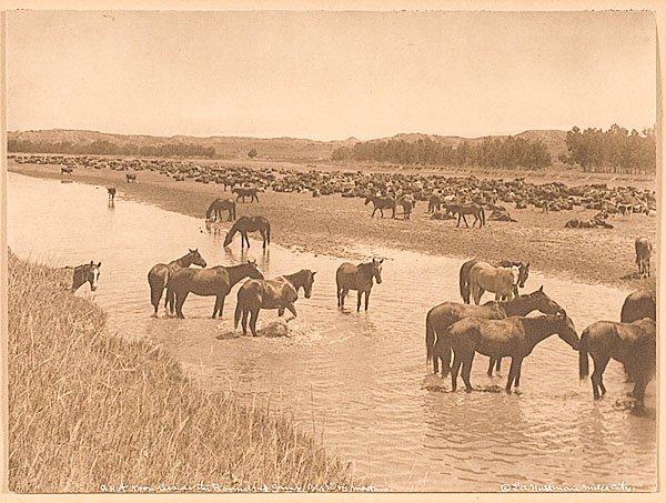 L.A. Huffman Signed Collotype "A Hot Noon...": L.A. Huffman Signed Collotype A Hot Noon Beside the Round-Up Camp. 7.25 x 10 in. photograph mounted on a larger 14 x 17.75 in. cardstock; inked along lower margin is title and Huffman's Mile City copy