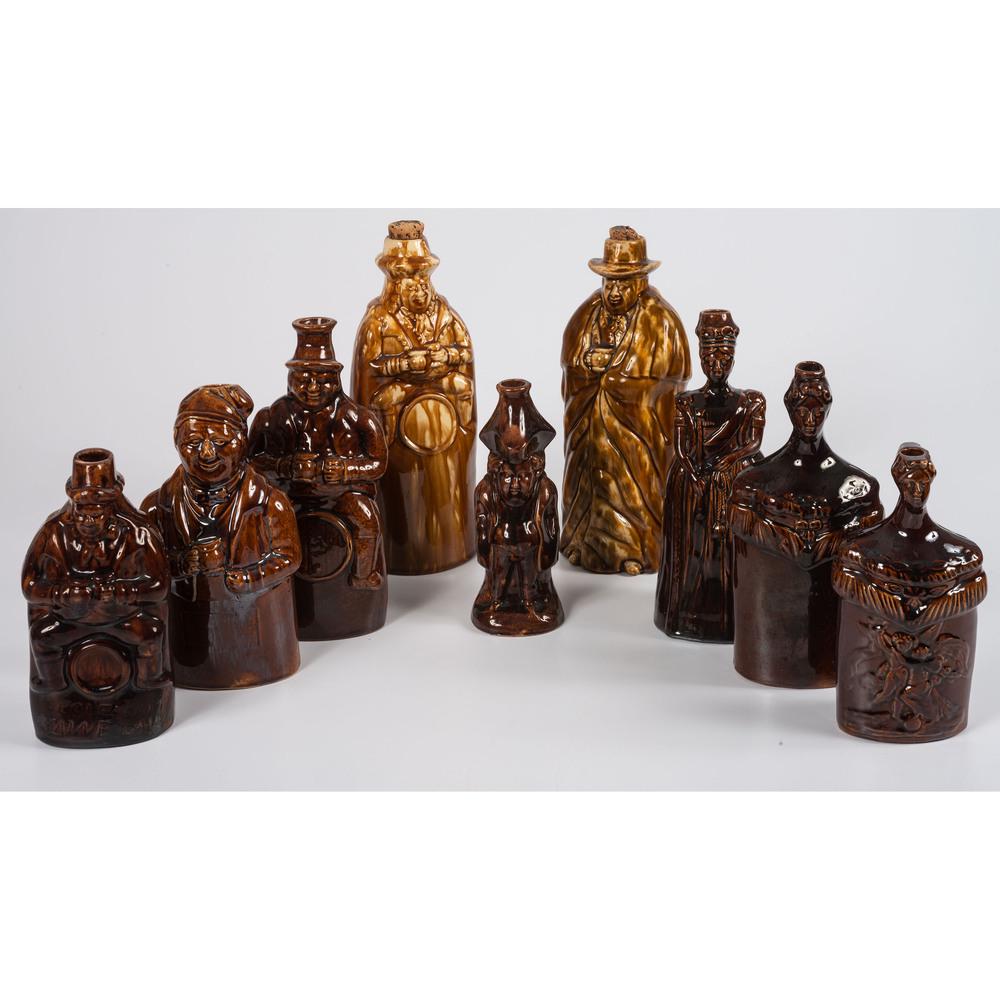 Nine Figural Flasks in Brown Glaze: English and American, 19th Century including one marked Patent 1849 / Bennington to underside. Height of largest 10 5/8 inches. Provenance: Property from the Estate of James A. Sanders, Evansville, In