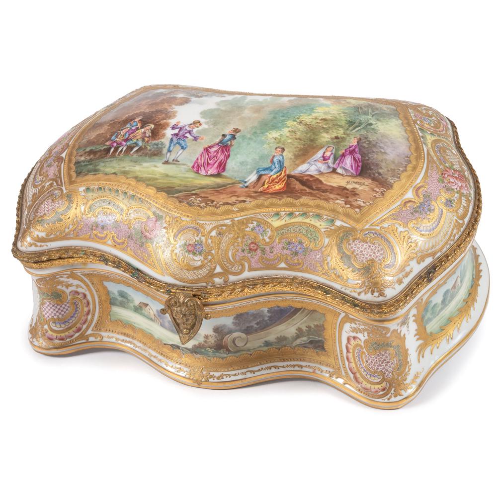 A Chateau de Versailles Porcelain Dresser Box: French, 19th/20th Century having ormolu mounts and gilt decoration and finely painted reserves of courtship and landscape scenes. signed G. Imonez to lid, with Chateau de Versailles mark to underside.