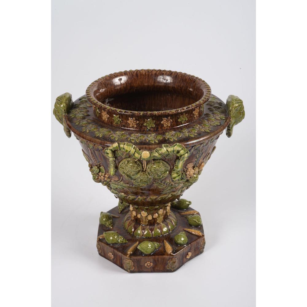 A Majolica Pottery Urn with Snails: Continental, Late 19th/Early 20th Century having lions head handles and raised naturalistic motifs. unmarked. Height 11 x diameter 11 inches. Provenance: Property from the Estate of James A. Sanders, 