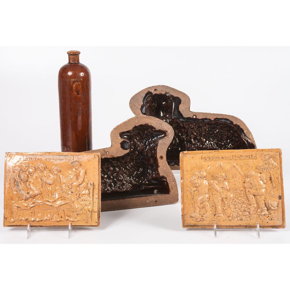 A Group of Continental Redware Including Two Plaques...: A Group of Continental Redware Including Two Plaques, a Bottle and a Lamb Mold 19th/20th Century bottle marked Curacao / Amsterdam, plaques inscribed Labor Overcomes all Things and Unity is Strength.