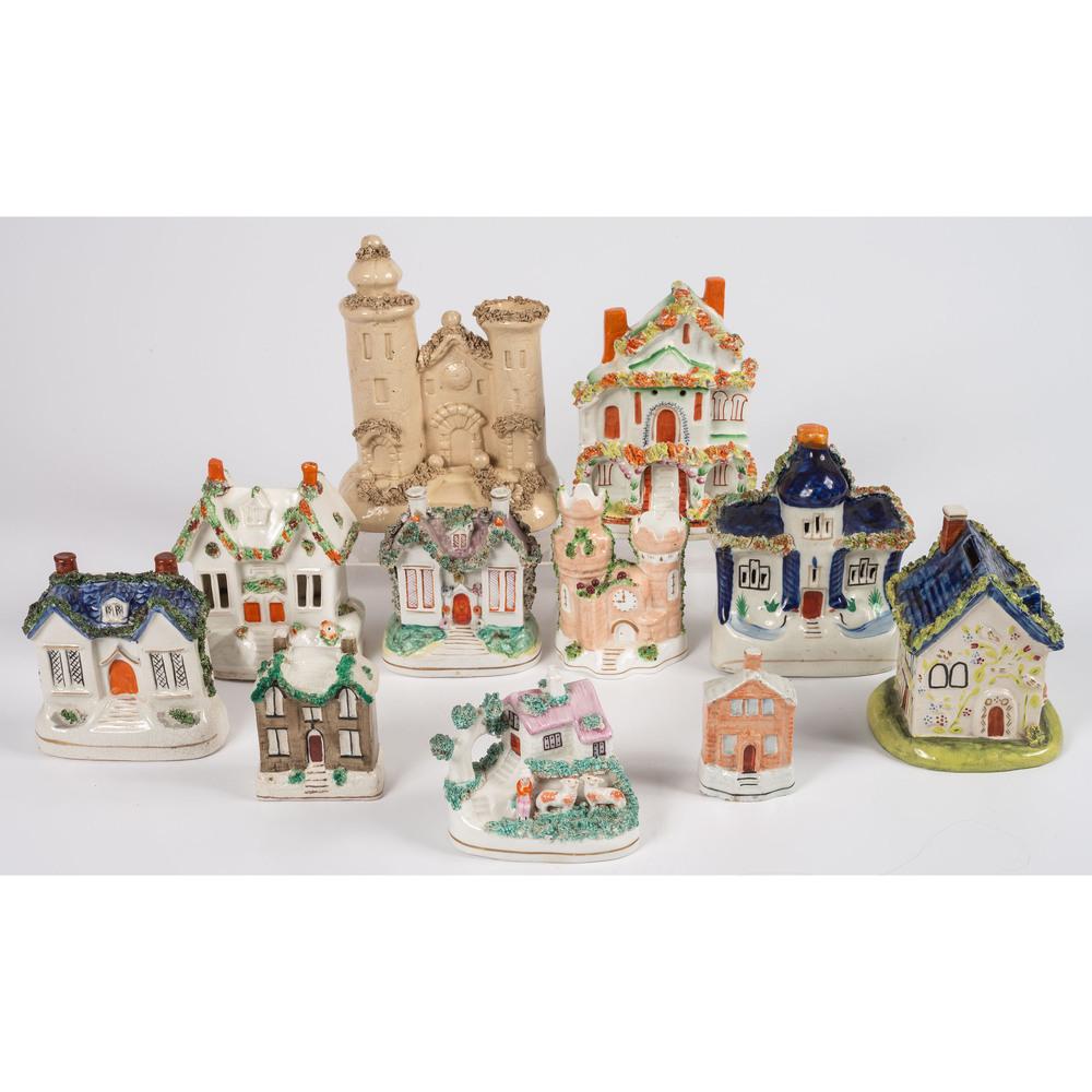Eleven Staffordshire House Figurines: 19th Century including five banks and one Coalport china castle. Height of largest 7 1/2 inches. Provenance: Property from the Estate of James A. Sanders, Evansville, Indiana Hindman is honored to pre