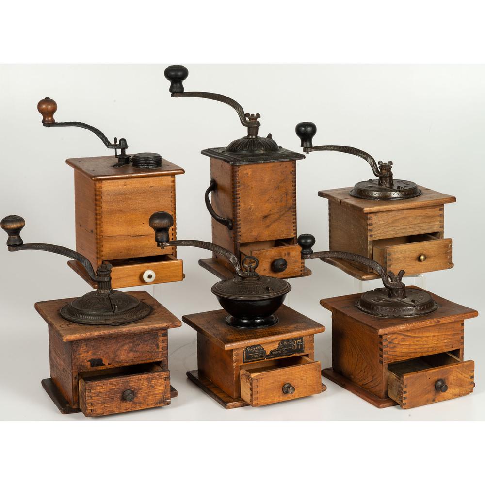 Seven Wooden and Iron Coffee Mills: 20th Century including Arcade and Charles Parker Co. Height of largest 13 1/2 inches. Provenance: Property from the Collection of Charlie Hinton, Baton Rouge, Louisiana