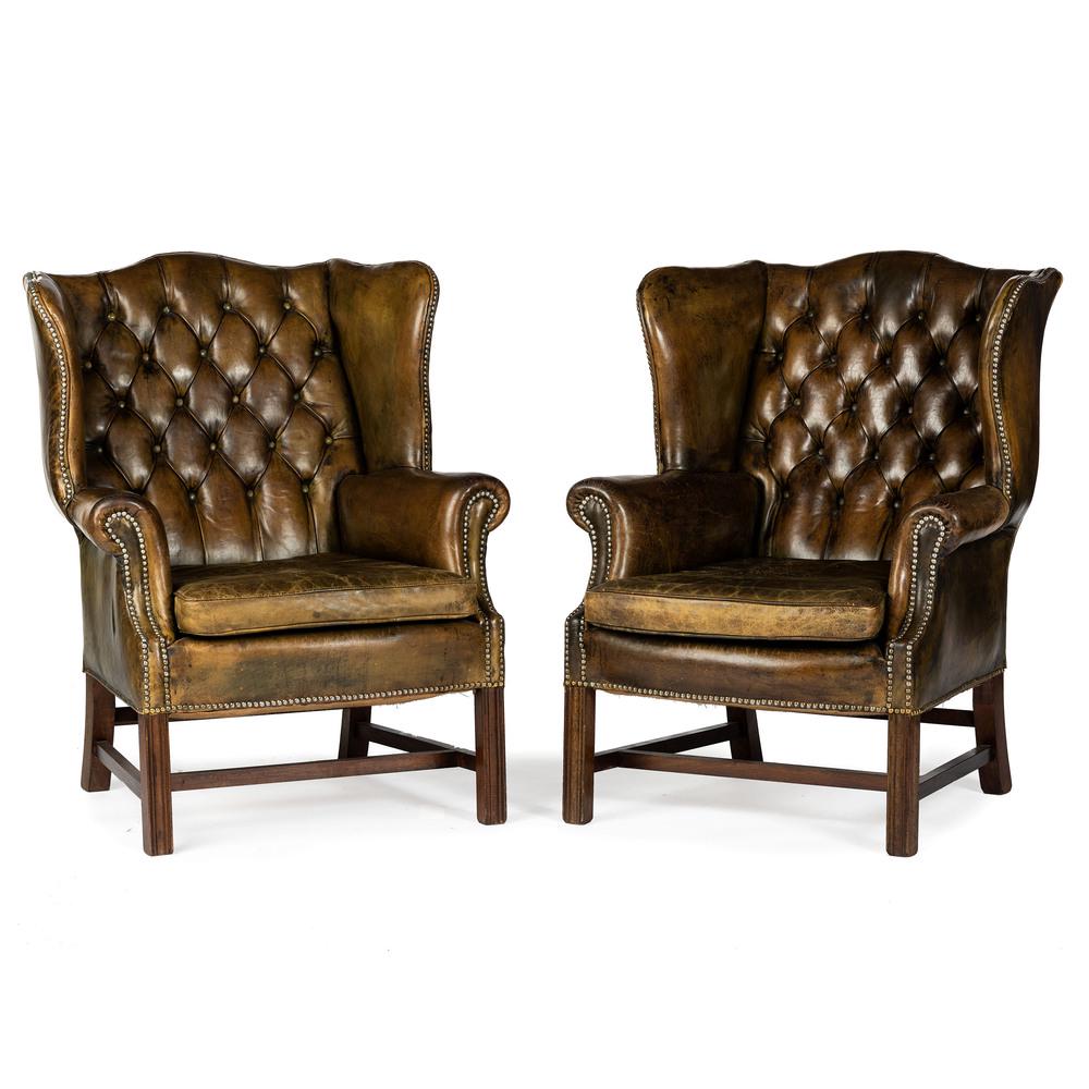 A Pair of Leather Upholstered Wingback Chairs: A Pair of Leather Upholstered Button Tufted Wingback Armchairs Height 40 inches. Provenance: Property from Brown Brothers Automotive formerly Brown Brothers Cadillac, Louisville, Kentucky