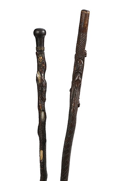 Skull and Serpent Motif Folk Art Canes : Skull and Serpent Motif Folk Art Canes, Lot of two. Includes one finely carved stained cane with serpent facing skull; also includes a carved lizard, frog, and human faces. Most of shaft has excellent