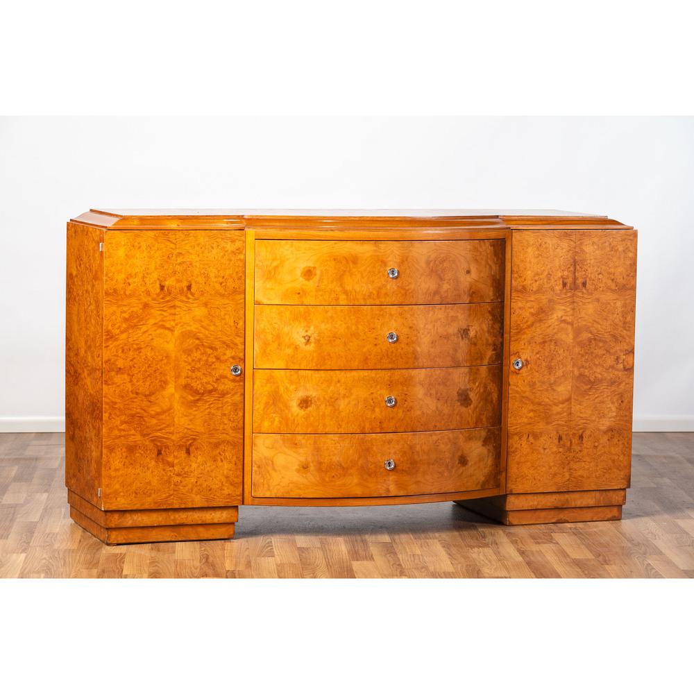 An Art Deco Buffet: An Art Deco Buffet French, Circa 1930s attributed to Soubrier, Paris amboyna, chrome Height 35 1/2 x width 62 x depth 17 1/4 inches.