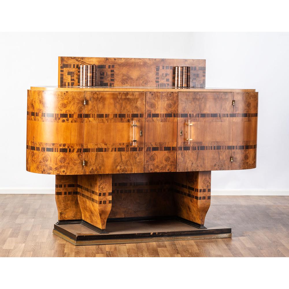 An Art Deco Cabinet: An Art Deco Cabinet Italian, 1934 walnut burl, primavera, and cocobolo veneers, acrylic, aluminum, brass, lacquered wood paper label to back Apr. 1934 Height 49 x width 66 x depth 21 inches.