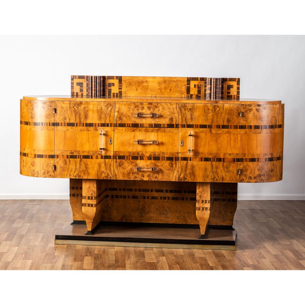An Art Deco Cabinet: An Art Deco Cabinet Italian, 1934 walnut burl, primavera and cocobolo veneers, acrylic, aluminum, brass, lacquered wood Height 47 x width 75 x depth 22 inches.
