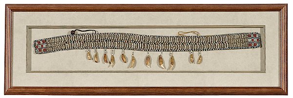 Eskimo Caribou Mandible Belt : Eskimo Caribou Mandible Belt Thread-sewn on hide and filled with 220 caribou mandibles framed by red, black blue, and white pony beads; decorated polar bear teeth drops, mounted and framed 53 in. x 