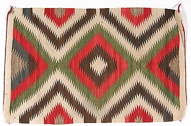 Navajo Eyedazzler Weaving: Navajo Eyedazzler Weaving. Hand-spun wool woven in a vibrating serrated pattern using colors of cream, brown, red, green, and blue, 42 in. x 26.25 in. second quarter 20th century