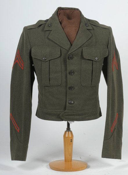 WWII U.S.M.C. "Ike" Jacket : WWII U.S.M.C. "Ike" Jacket Corporal stripes, enlistment stripe, 1 overseas stripe; on half mannequin.