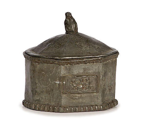 Georgian Lead Pewter Tobacco Box : Georgian Lead Pewter Tobacco Box English, late 18th/early 19th century. A Georgian lead pewter tobacco box of canted oblong form. The domed lid has a cloaked figure finial, the front with relief pan