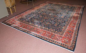 Kashan Rug : Kashan Rug Iranian, first quarter 20th century, having an all-over pattern of stylized arabesques on a coral field with a sapphire border; 9ft. 8 in. x 13 ft. 5 in. (118 x 162 in.; 287 x 360.7cm).