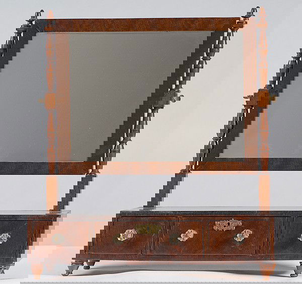 Federal Mahogany Shaving Mirror : Federal Mahogany Shaving Mirror American, early 20th century, a Federal mahogany shaving mirror with a tilting mirror on block and turned posts over a three drawer case with glass knobs; ht. 24, lg.