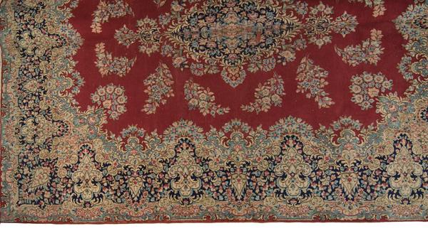 Hamadan Rug : Hamadan Rug Iranian, 20th century. A large Hamadan rug with floral design on a red ground with blue border; 13 ft. x 9 ft. 10 in.