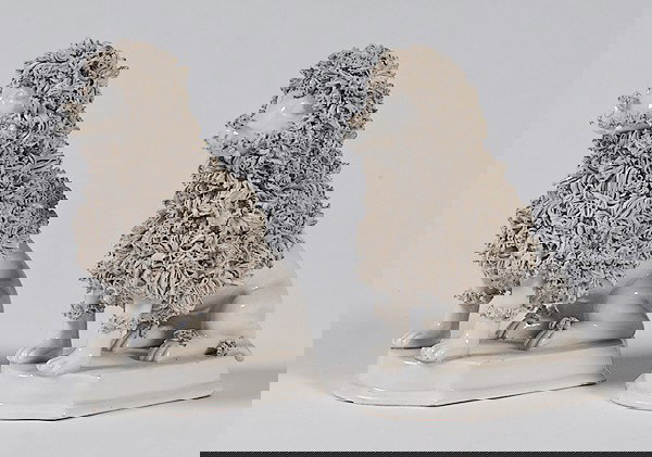 Pair of Italian Creamware Poodles : Pair of Italian Creamware Poodles Italian, 19th century, a pair of Italian creamware poodles mounted on a square plinth, marked R230/A Italy; ht. 7 in.