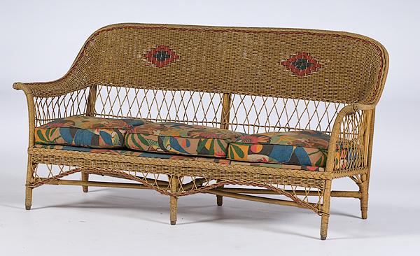 Wicker Settee : Wicker Settee American, ca 1940s, settee with rounded back continuing into arms, the seat strung and with three (later) covered cushions; ht. 34.5, wd. 69, dp. 23 in.