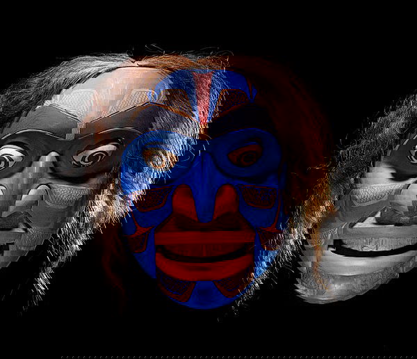 Don Lelooska Kwakiutl Articulating Mask : Don Lelooska Kwakiutl Articulating Mask Carved of wood with large rolling eyes and movable jaw exposing a toothy smile; with horsehair hair and painted in blue, red, and black, height 16 in. x width