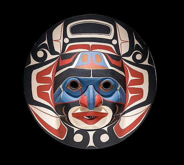 Don Lelooska Kwakiutl Sun Halo Mask : Don Lelooska Kwakiutl Sun Halo Mask Carved with ovoid eyes and pursed lips; painted in red, blue, black, and cream; signed in pencil Lelooska, diameter 22.5 in.; third quarter 20th century. Exhibite
