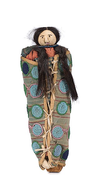Salish Toy Cradle with Hide Doll : Salish Toy Cradle with Hide Doll Wood backboard with circular beaded designs in green light blue and navy blue, outlined in pink or green beads against a print cloth background, length 10 in.; late 