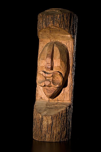 Iroquois False Face Carving : Iroquois False Face Carving Unfinished image of a face emerges from a section of carved tree, height 31 in.; second quarter 20th century.